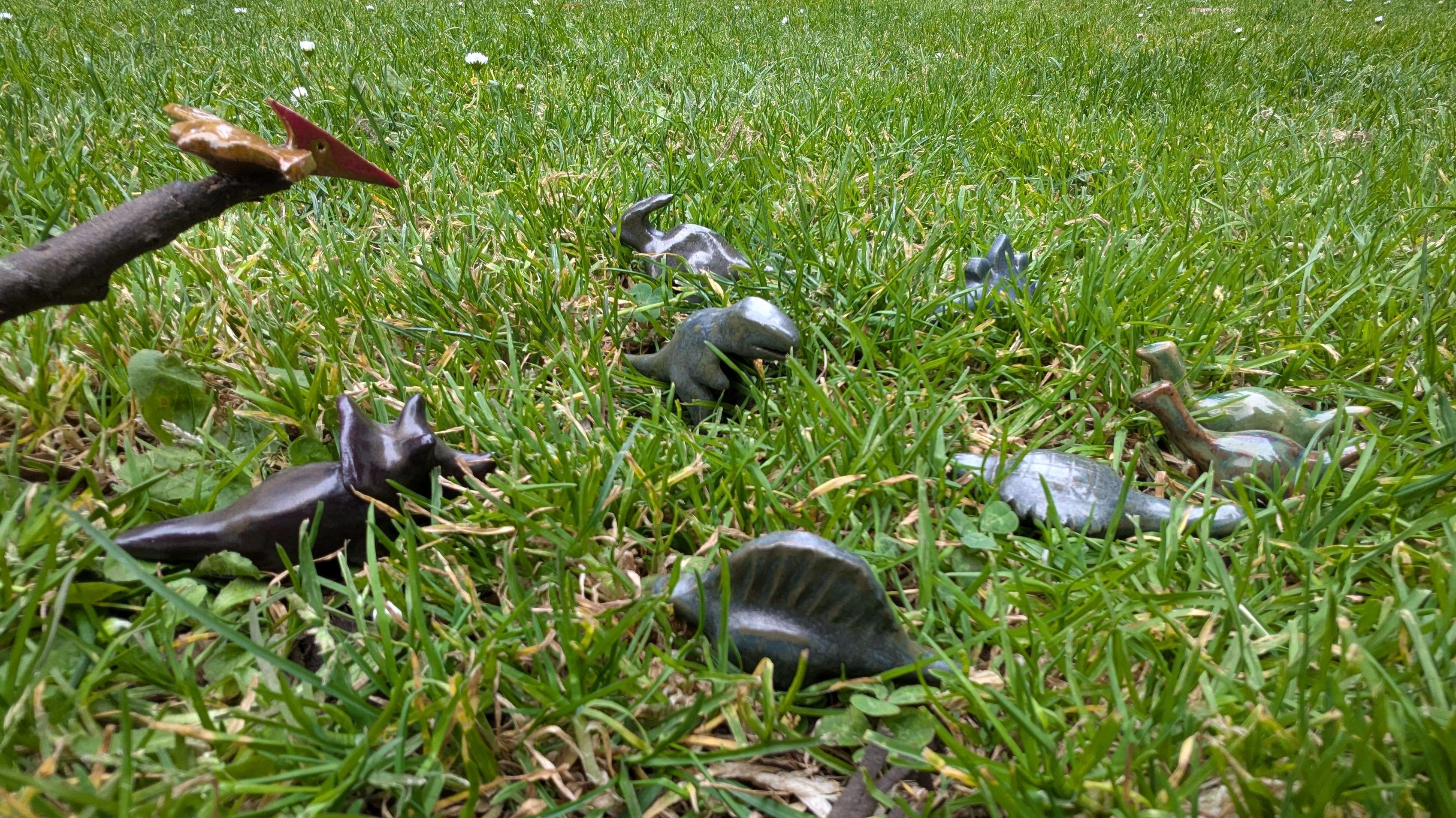 A low-angle shot of each of the types of dinosaurs I've made, with the large version of the pterodactyl balancing on a stick so it looked more airborne.